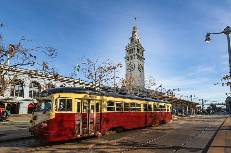 A tram in front of the San Francisco Ferry Building on The Embarcadero A tram in front of the San Francisco Ferry Building on The Embarcadero